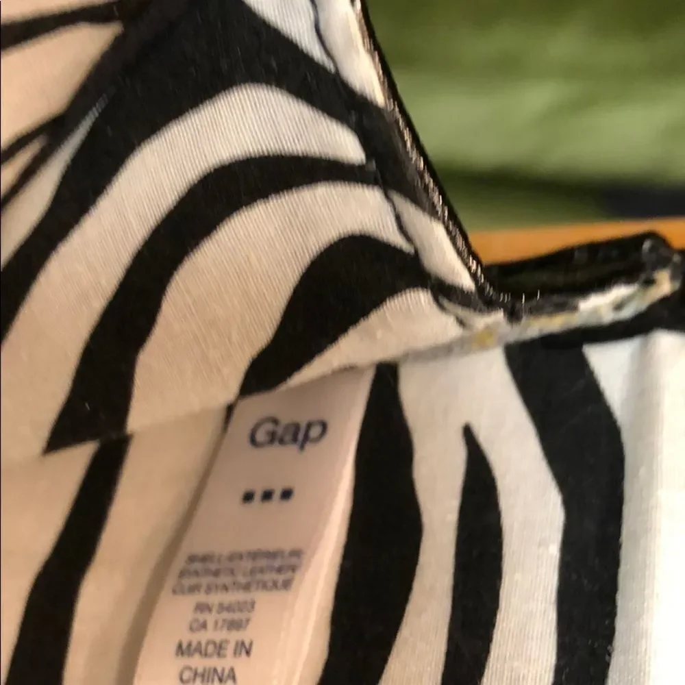 Gap black shiny clutch with zebra print inside